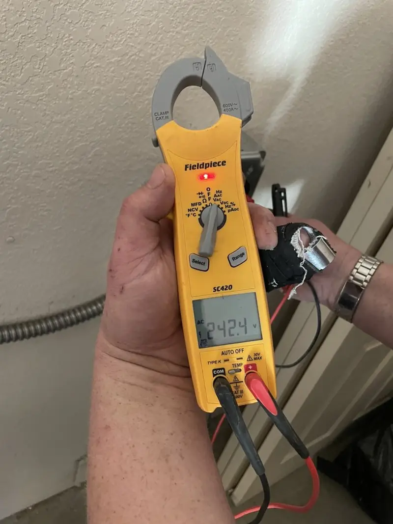Voltage testing with clamp meter during Whole House Surge Protector in Algoma